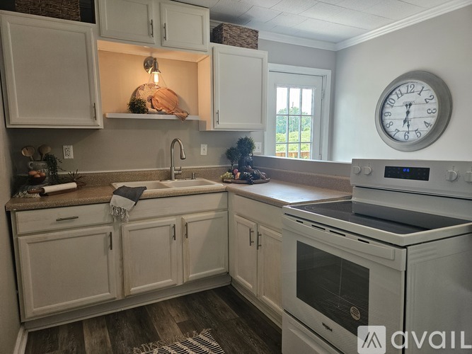 A kitchen with white cabinets and a white oven.