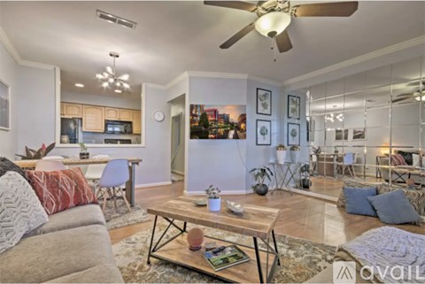 A living room with a grey couch and a coffee table in the middle.