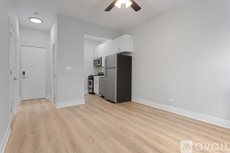 A kitchen area with a refrigerator, microwave, and oven.