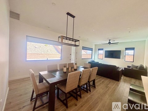 A modern dining room with a large table and chairs.