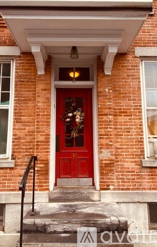 A red door with a wreath on it.