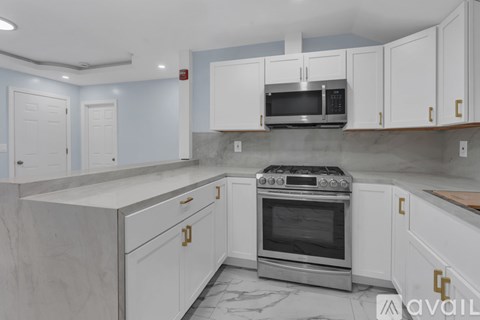 A kitchen with a stove top oven and a microwave above it.