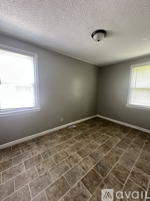A kitchen with a white stove and a white refrigerator.