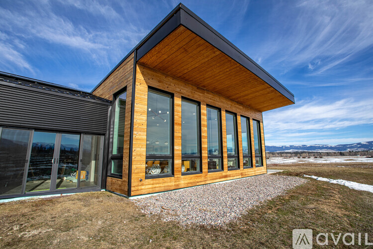 A modern house with a wooden exterior and large windows.