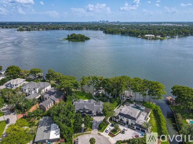 A bird's eye view of a residential area with houses and a body of water.