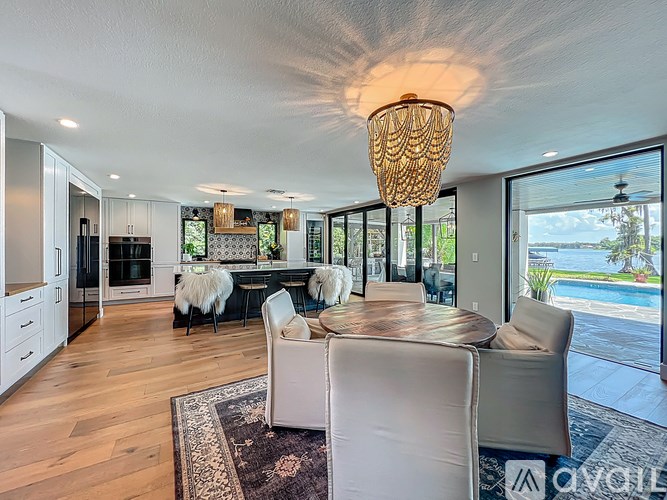 A modern dining room with a round table and chairs.