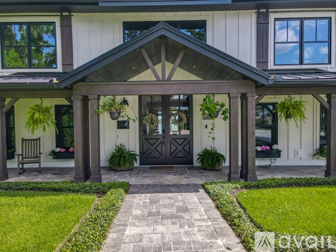 A white house with a black door and windows.