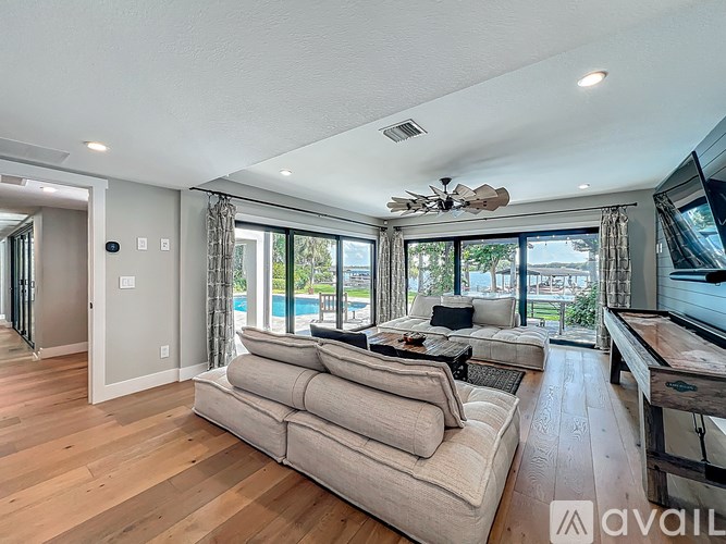 A living room with a large couch and a television.