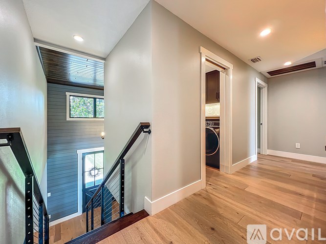 A spacious interior of a house with a staircase leading to the upper floor.