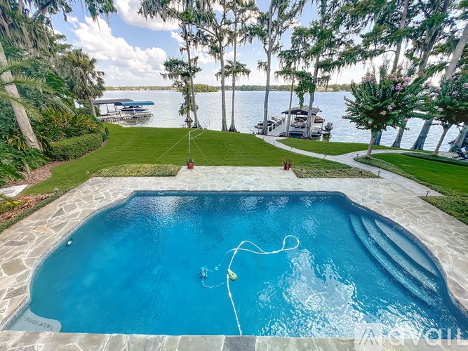 A swimming pool with a slide and a waterfall.