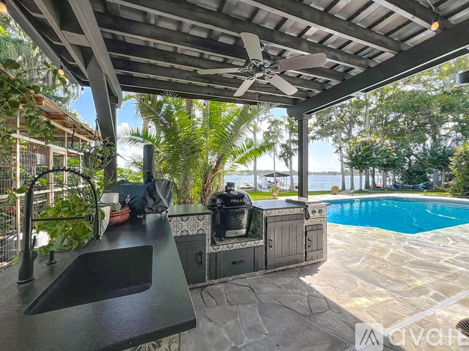 A patio with a black counter and a ceiling fan.