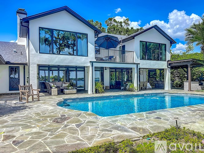 A large house with a swimming pool in the backyard.