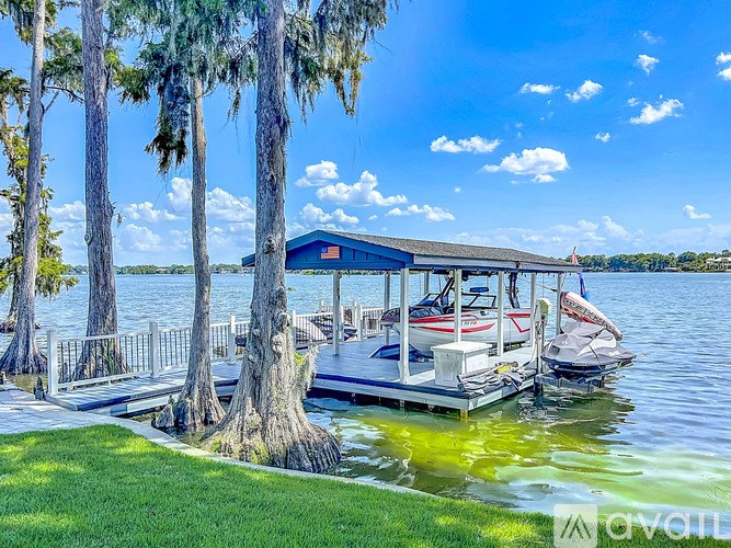 A boat is docked at a pier on a sunny day.