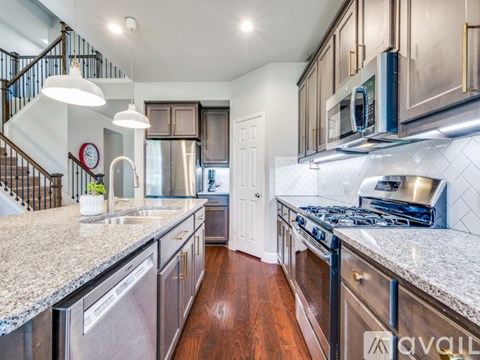 A kitchen with a stainless steel dishwasher and a stove top oven.