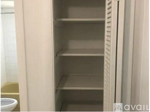 Empty white shelves in a refrigerator.