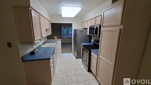 A kitchen with a blue countertop and white cabinets.