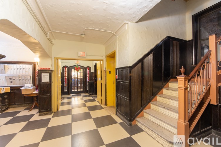 A hallway with a black and white checkered floor.
