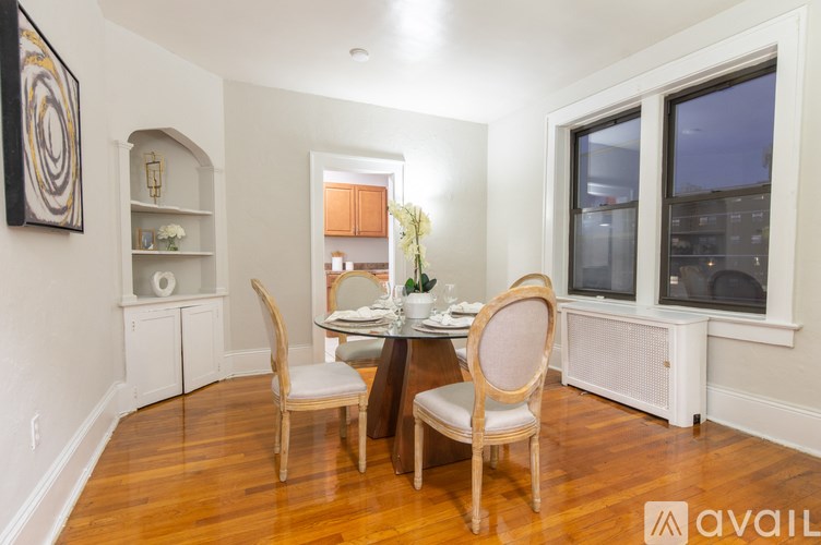 A dining room with a table set for two and a view of the city.