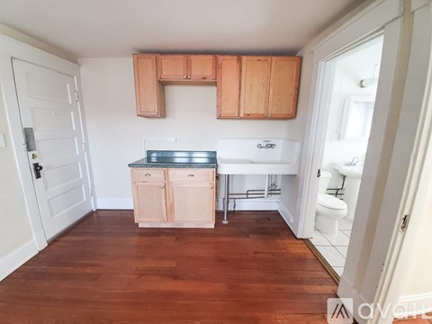A kitchen with wooden cabinets and a white fridge.