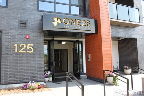 The front of a building with a sign that says "ONE25" above the door.