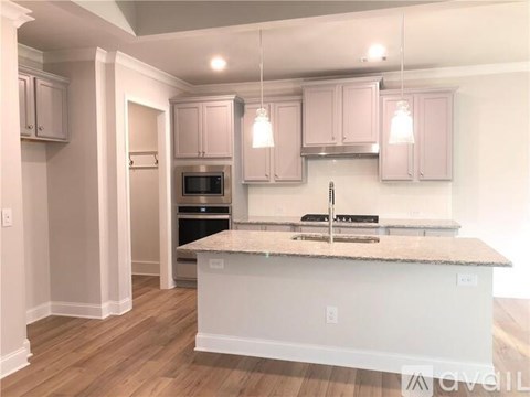 A kitchen with a white countertop and pink cabinets.