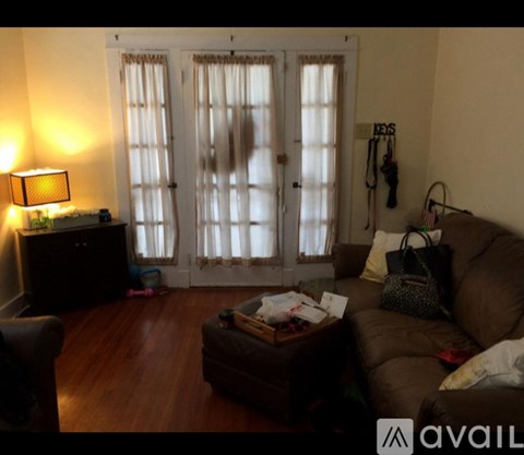 A living room with a brown couch and a wooden coffee table.