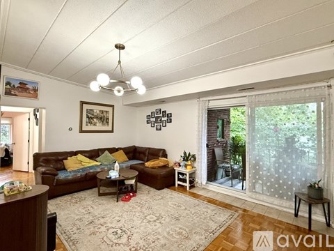 A living room with a brown couch and a coffee table.