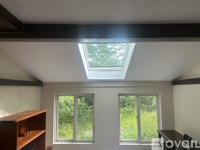 A room with a tiled floor and a window letting in sunlight.