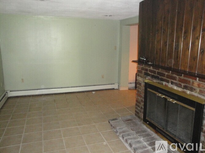 A room with a fireplace and tile flooring.