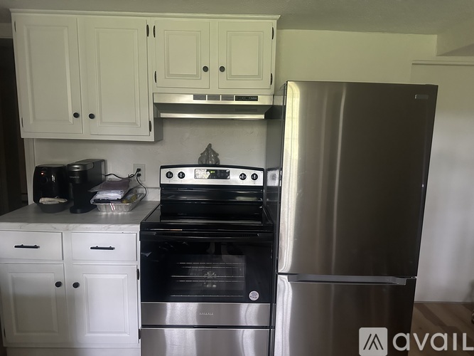 A kitchen with a stove, oven, and refrigerator.