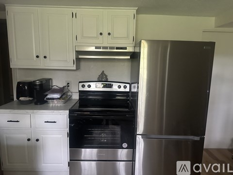 A kitchen with a stove, oven, and refrigerator.
