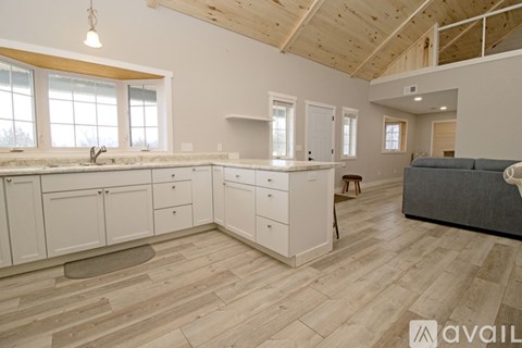 A kitchen with a white refrigerator and a black stove top oven.