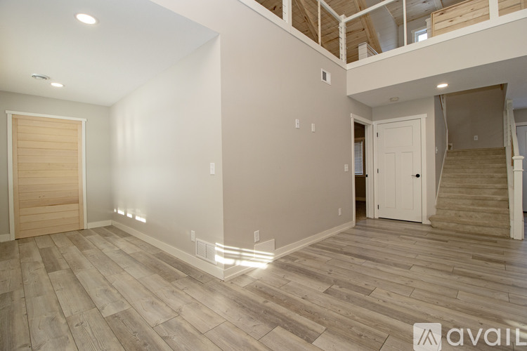 A kitchen with wooden floors and cabinets.