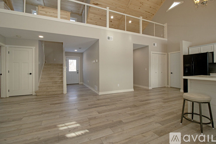A room with wooden flooring and a ceiling fan.