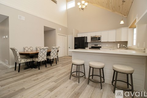 A room with wooden flooring and a ceiling fan.