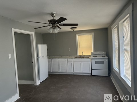 A kitchen with a white refrigerator, white cabinets, a white stove, and a white oven.