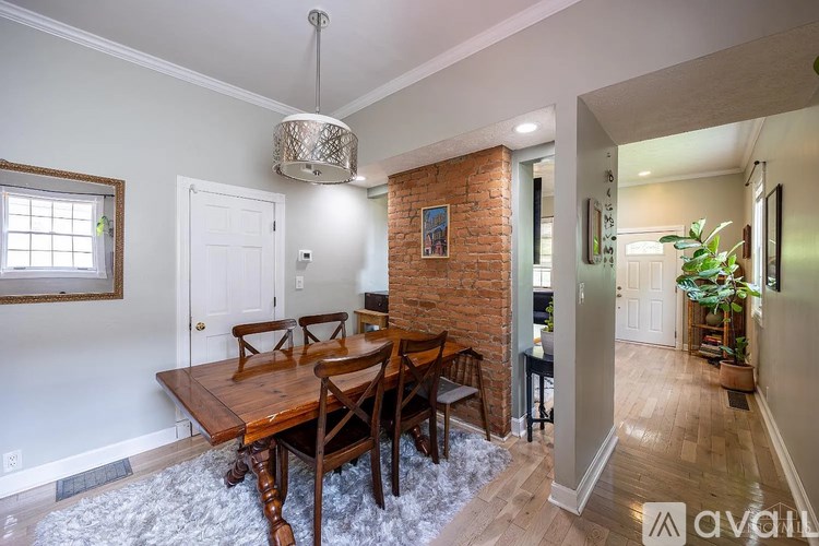 A dining room with a wooden table and chairs.