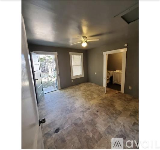 A room with a ceiling fan and tile flooring.