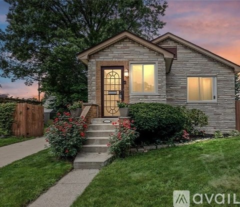 A house with a front yard and a wooden fence.