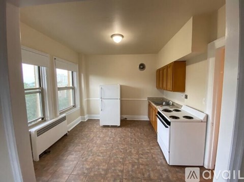A kitchen with a white refrigerator and stove top oven.