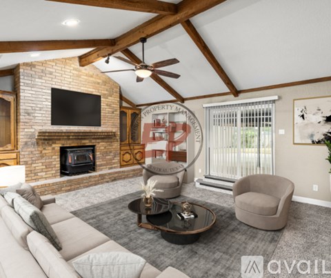 A living room with a fireplace and a television mounted above it.