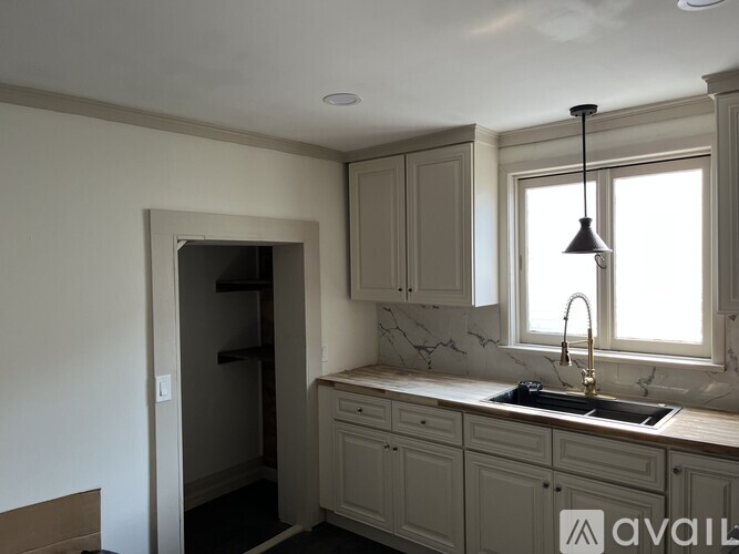 A kitchen with a sink and a window.