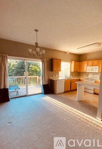 A kitchen with wooden cabinets and a dining table is available for rent.