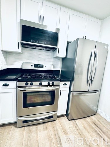 A kitchen with a stainless steel refrigerator and oven.