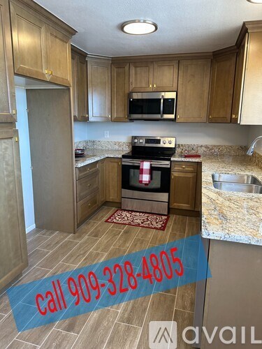 A kitchen with a stove top oven and a counter top with a sink.