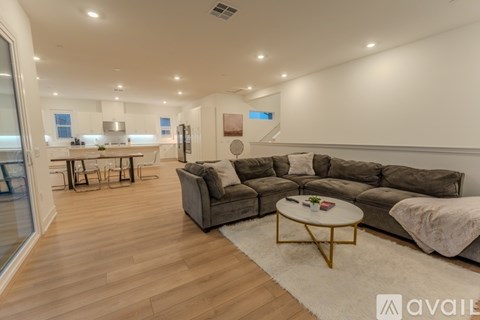 A living room with a grey sofa and a coffee table.