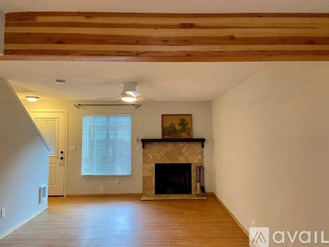 A living room with a fireplace and a painting on the wall.