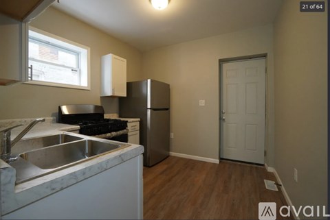 A kitchen with a sink, stove, and refrigerator.