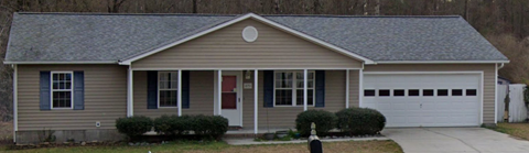 A house with a red door and a garage door.