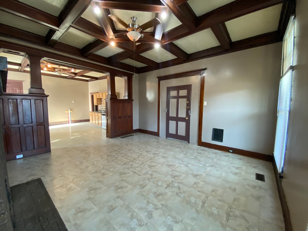 A large empty room with a wooden ceiling and floor.